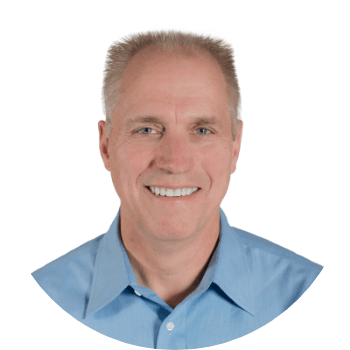 Photo of a man smiling and wearing a light blue shirt